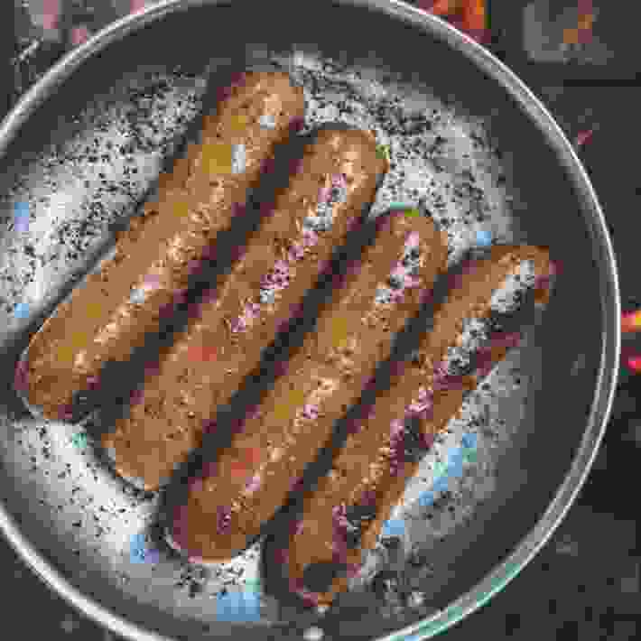 Brats Cooking In Pan