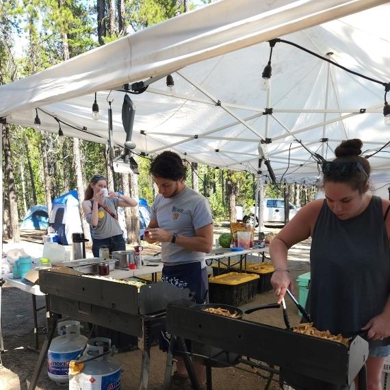 Camp Chef Anthony and a camper cooking