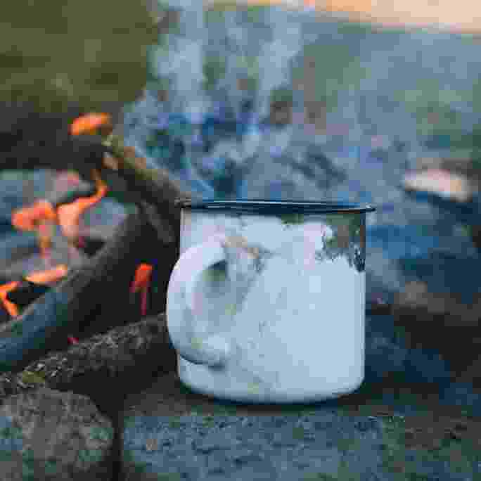Coffee cup by a fire