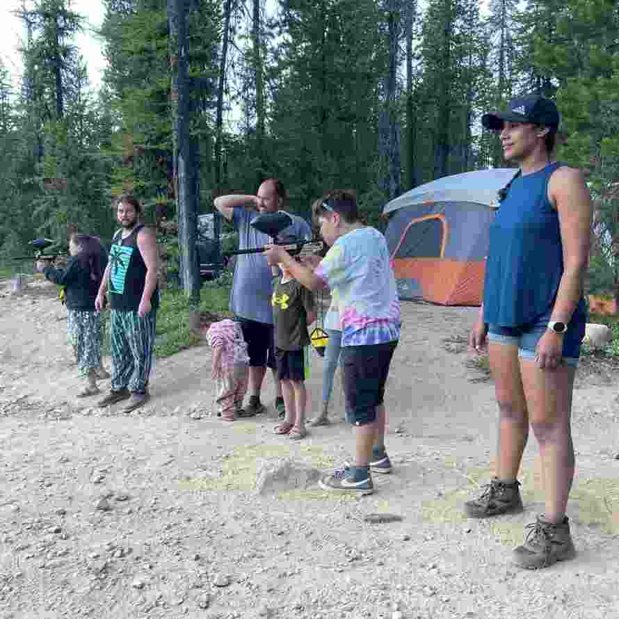 Camper shooting at targets with paintball guns