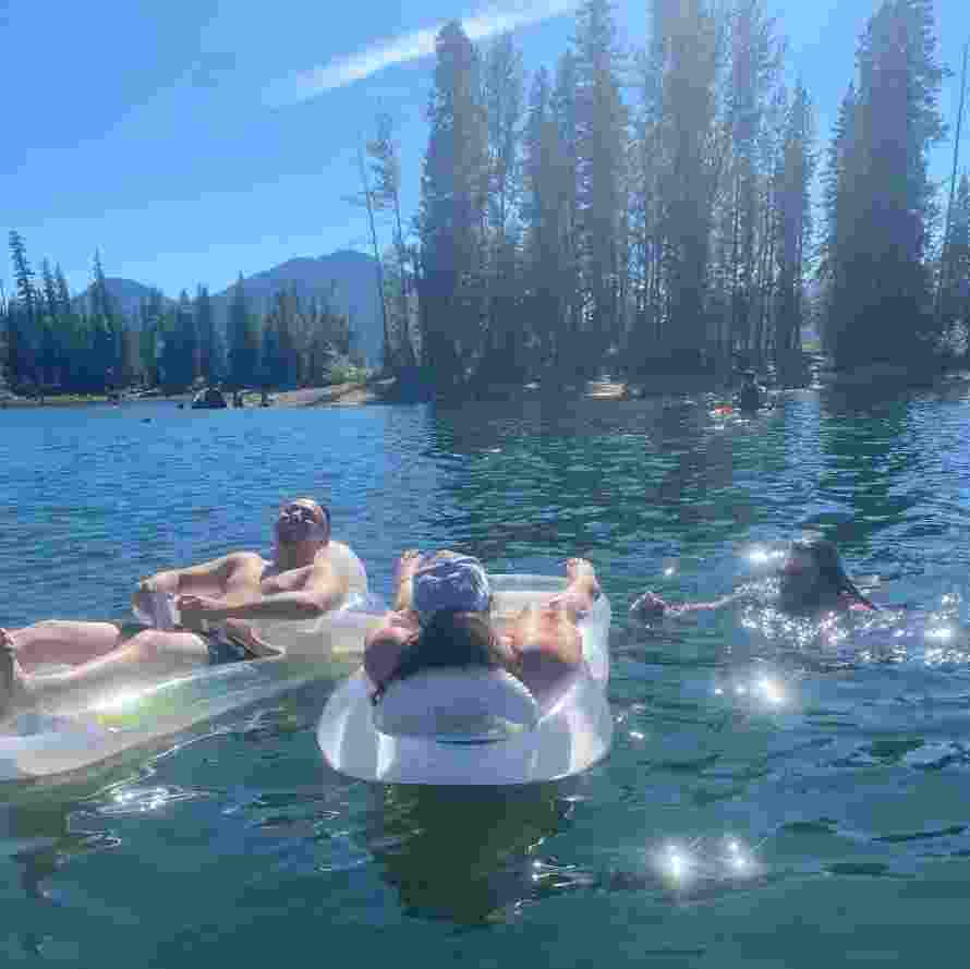 3 Campers swimming in a Lake